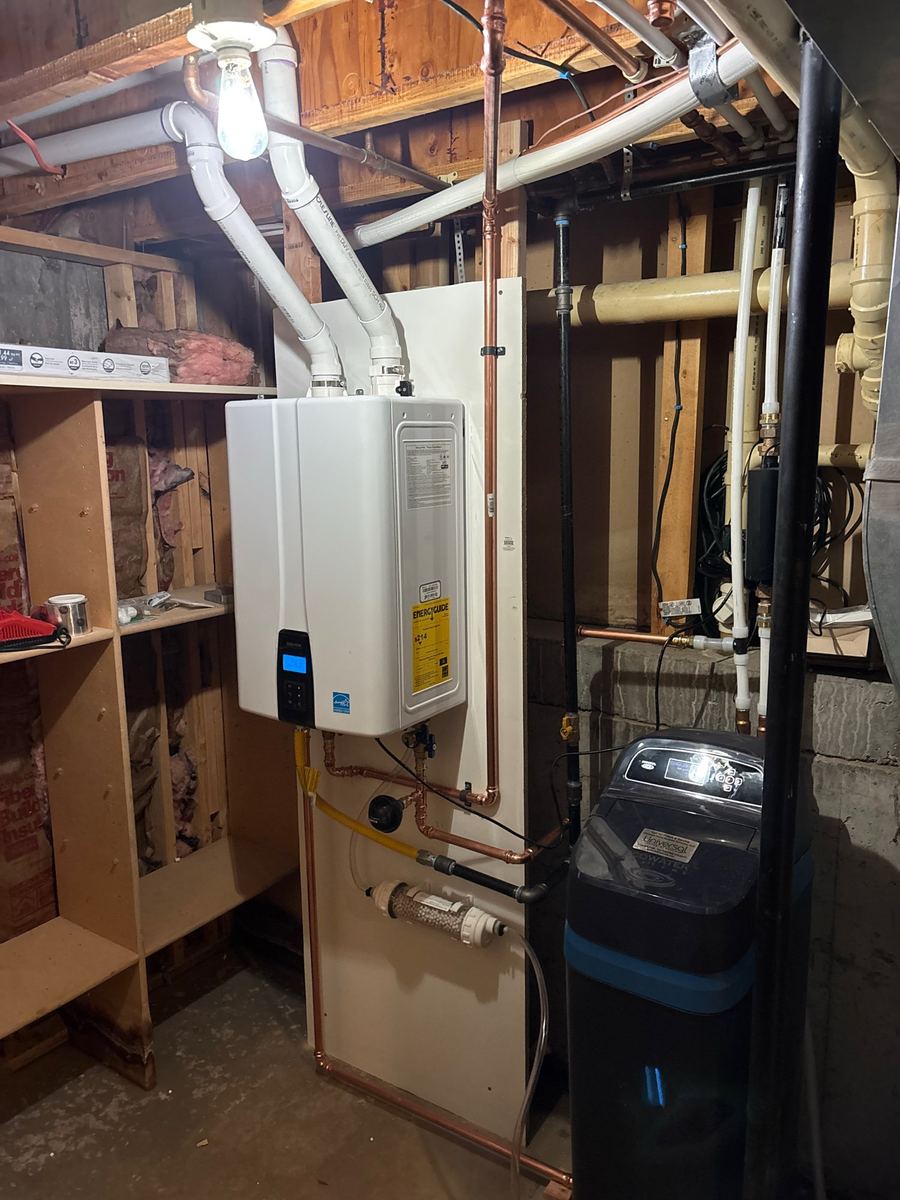 Tankless water heater installed in a basement mechanical room, financing available through Wisetack