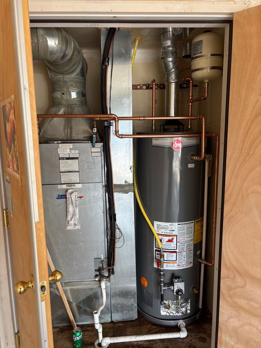 Tank water heater installed in a utility closet, financing available through Wisetack