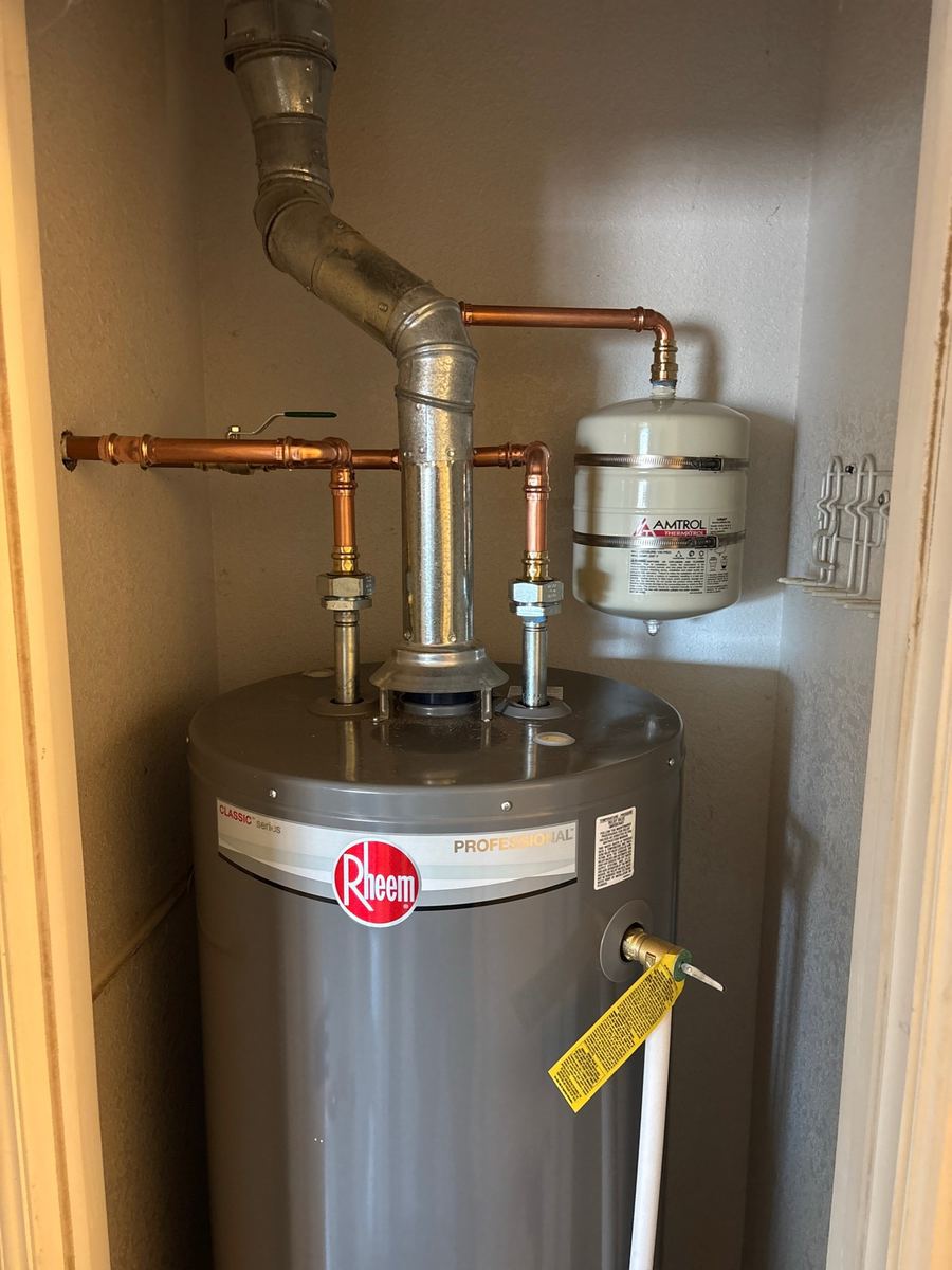 Newly installed tank water heater with copper piping and expansion tank in a Pueblo, Colorado home